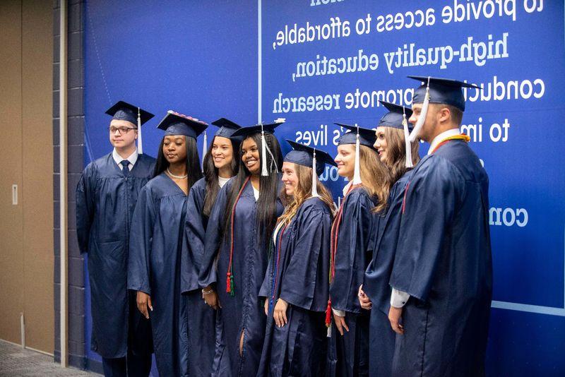 Graduating students posing in the Health and Wellness Building at Penn State Schuylkill